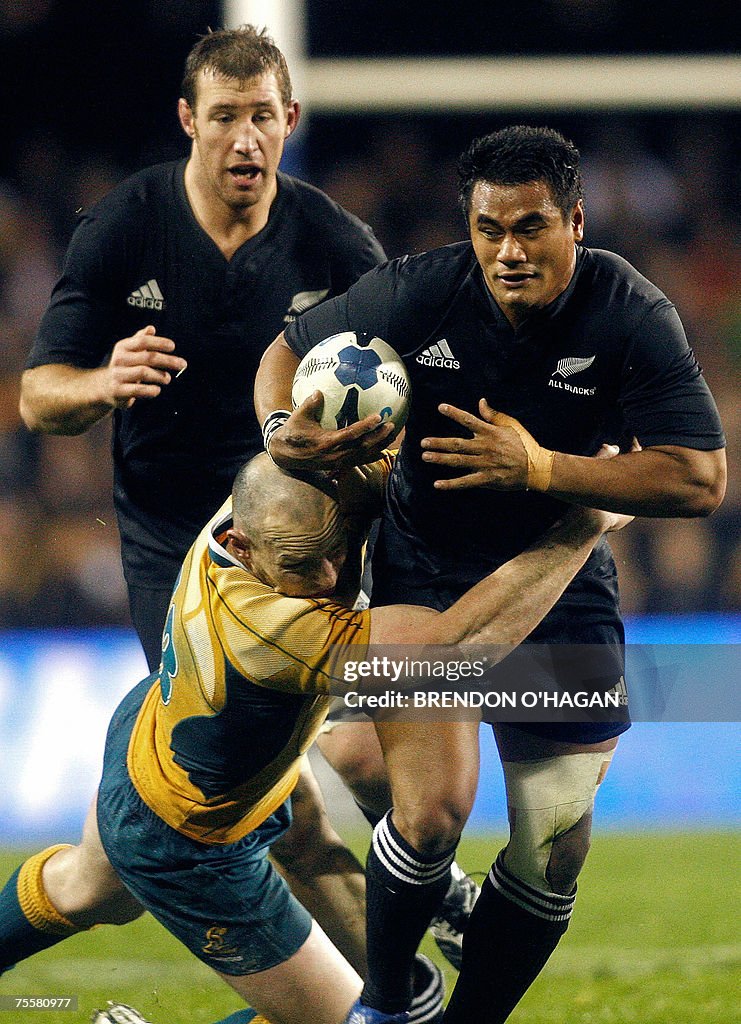 All Black's Isaia Toeava (C) is tackled...