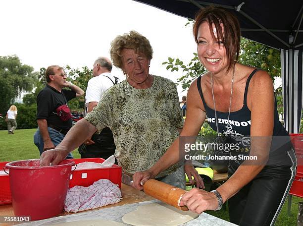Gabriele Pauli , district administrator of the Bavarian district Fuerth helps to prepare pizza dough with a rolling pin during a motorcycle tour on...