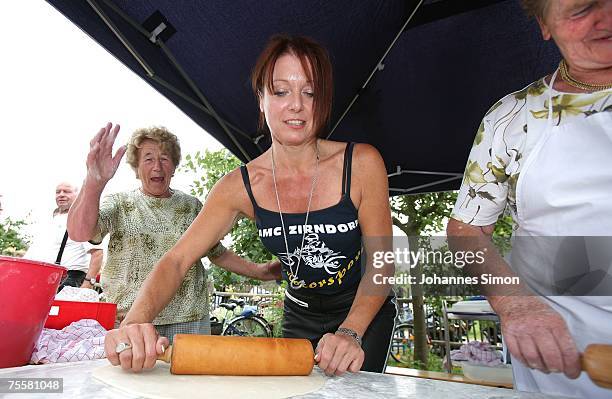 Gabriele Pauli , district administrator of the Bavarian district Fuerth helps to prepare pizza dough with a rolling pin during a motorcycle tour on...