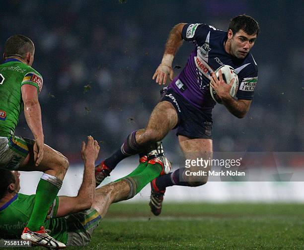 Cameron Smith of the Storm tries to evade a tackle during the round 19 NRL match between the Melbourne Storm and the Canberra Raiders at Olympic Park...