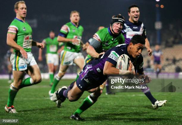 Israel Folau of the Storm dives to score during the round 19 NRL match between the Melbourne Storm and the Canberra Raiders at Olympic Park July 21,...
