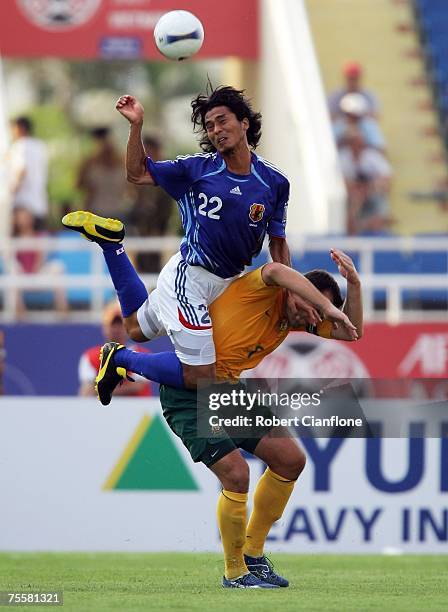 Yuji Nakazawa of Japan challenges Mark Viduka of Australia during the AFC Asian Cup 2007 Quarter Final between Japan and the Australian Socceroos at...