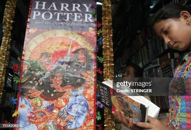 An Indian child reads ahead of a promotional event for the release of the latest 'Harry Potter' book at a bookshop in Siliguri, 21 July 2007. The...