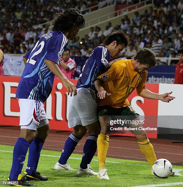 Harry Kewell of Australia is pressured by his opponents during the AFC Asian Cup 2007 Quarter Final between Japan and the Australian Socceroos at My...