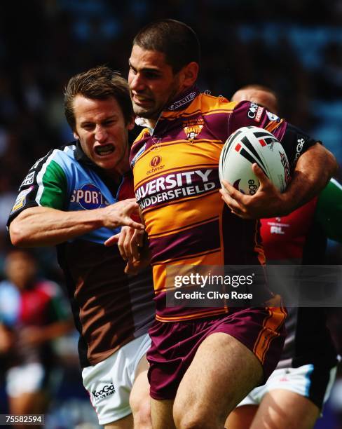 Mark McLinden of Harlequins RL tries to tackle Chris Nero of Huddersfield as he scores a try Giants during the engage Super League match between...