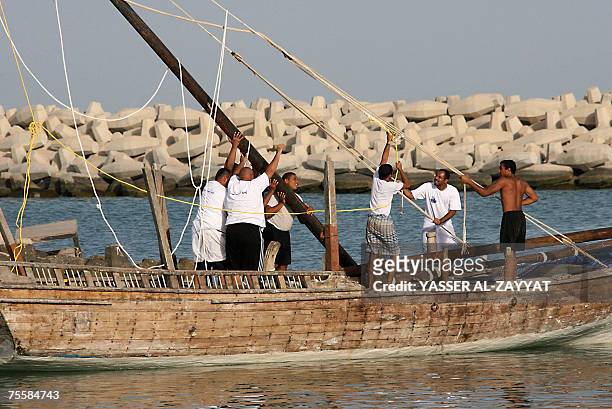 Kuwaiti pearl divers fix a dhow 21 July 2007 during preparations in Kuwait City for the upcoming annual pearl diving season. Pearl-diving trips are...