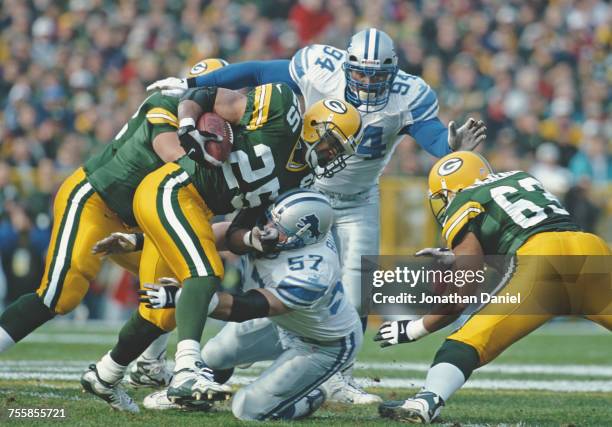 Dorsey Levens, Running Back for the Green Bay Packers is tackled by Stephen Boyd, Linebacker for the Detroit Lions whilst running the ball during...