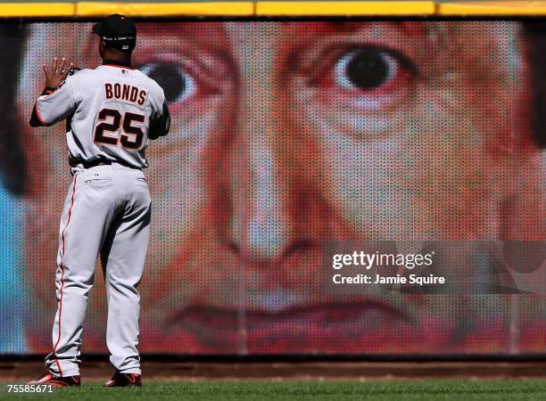 Barry Bonds of the San Francisco Giants warms up in front of an outfield asvertisement prior to the fifth inning of the game against the Milwaukee...