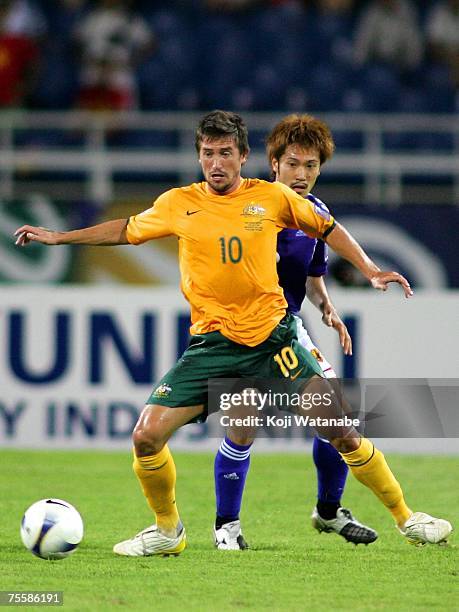 Yuki Abe of Japan and Harry Kewell of Australia battle for the ball during the AFC Asian Cup 2007 Quarter Final between Japan and the Australian...