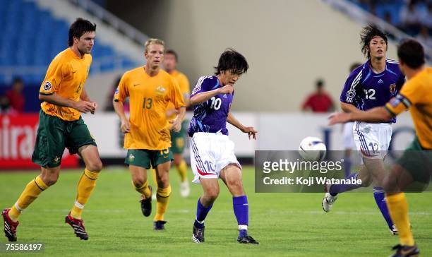 Shunsuke Nakamura of Japan and Michael Beauchamp of Australia battle for the ball during the AFC Asian Cup 2007 Quarter Final between Japan and the...