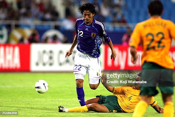 Yuji Nakazawa of Japan and Tim Cahill of Australia battle for the ball during the AFC Asian Cup 2007 Quarter Final between Japan and the Australian...
