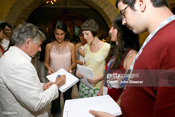 Director Roman Polanski signs autographs for student jurors at a dinner at Divina Commedia during the Giffoni Film Festival on July 21, 2007 in...