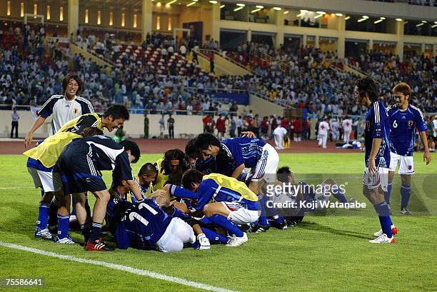 Japanese players celebrate their 4-3 victory on penalties at the close of the AFC Asian Cup 2007 Quarter Final match against the Australian Socceroos...