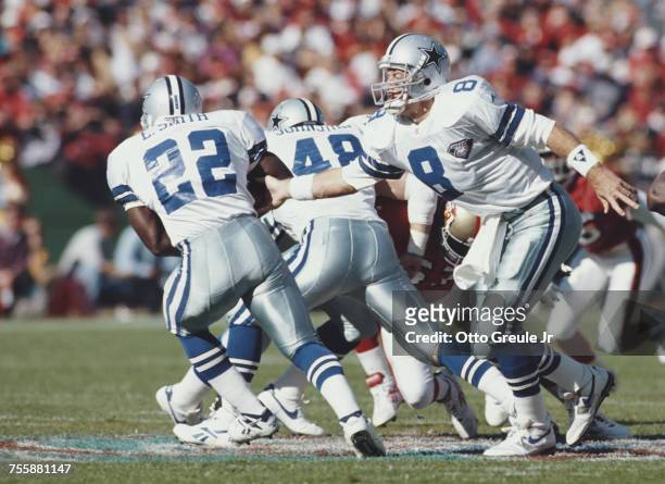 Troy Aikman, Quarterback for the Dallas Cowboys hands off to running back Emmitt Smith during the National Football Conference West game against the...