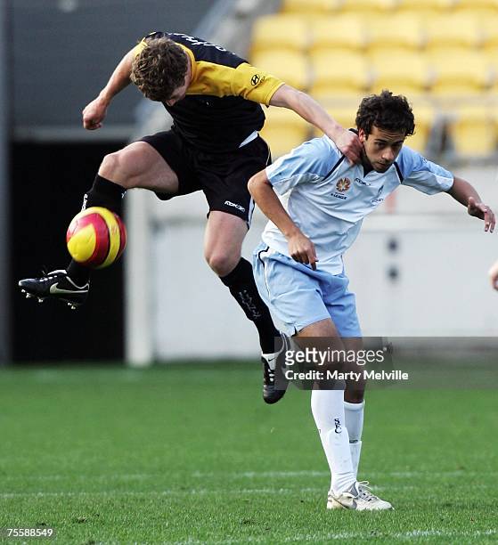 Tony Lochhead of the Phoenix uses Alex Brosque of Sydney to take a high pass during the A-League Pre-Season Cup match between the Wellington Phoenix...