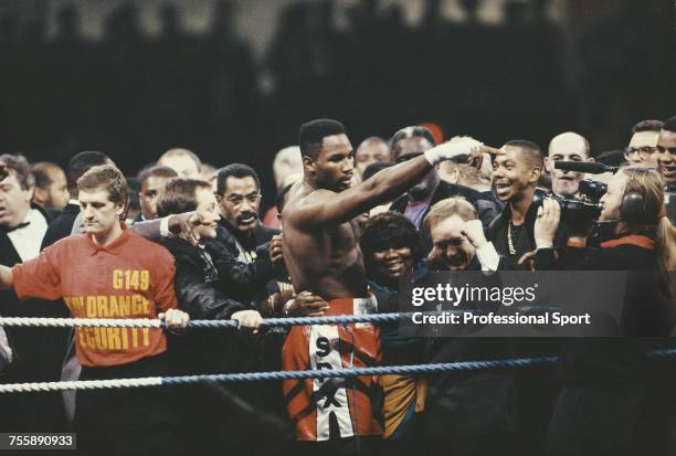 Canadian born British heavyweight boxer Lennox Lewis celebrates with members of this entourage and corner team, including manager Frank Maloney ,...