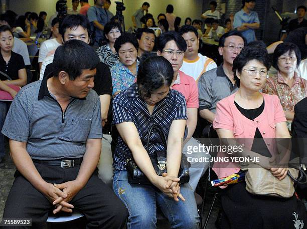 Relatives of kidnapped South Koreans in Afghanistan gather to watch TV news reports at a restaurant in Seongnam, south of Seoul, 22 July 2007....