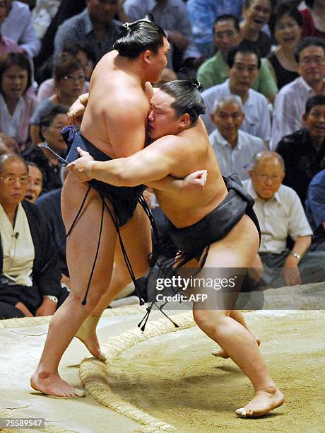 Mongolian sumo yokozuna, or grand champion, Asashoryu pushes out his rival and compatriot Hakuho on the final day of the Nagoya Grand Sumo Tournament...