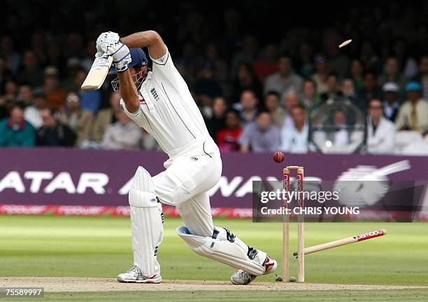 London, UNITED KINGDOM: England captain Michael Vaughan's off stump is sent flying after being bowled by India's Rudra Pratap Singh during the fourth...