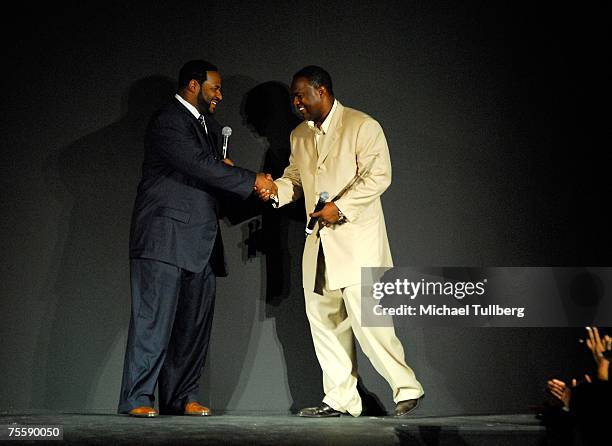 Former NFL football star Jerome Bettis is honored by former NFL quarterback Rodney Peete onstage at the "Designcare 2007" celebrity benefit held by...