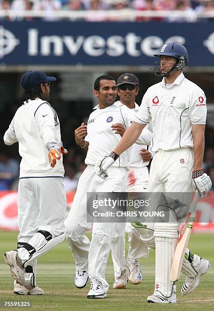 London, UNITED KINGDOM: Indian bowler Zaheer Khan celebrates with Mahendra Dhoni and Rahul Dravid after taking England's batsman Chris Tremlett's...