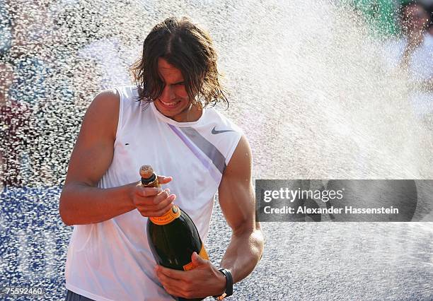 Rafael Nadal of Spain celebrates with champagne after winning the Mens final against Stanislas Wawrinka of Switzerland at the MercedesCup at TC...