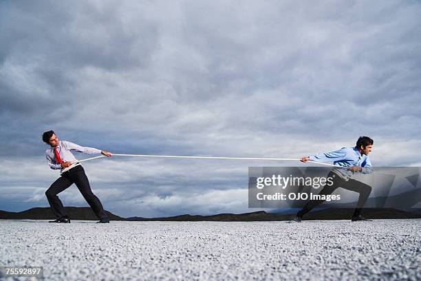 dos hombres al aire libre en cuerda de guerra - pulling fotografías e imágenes de stock