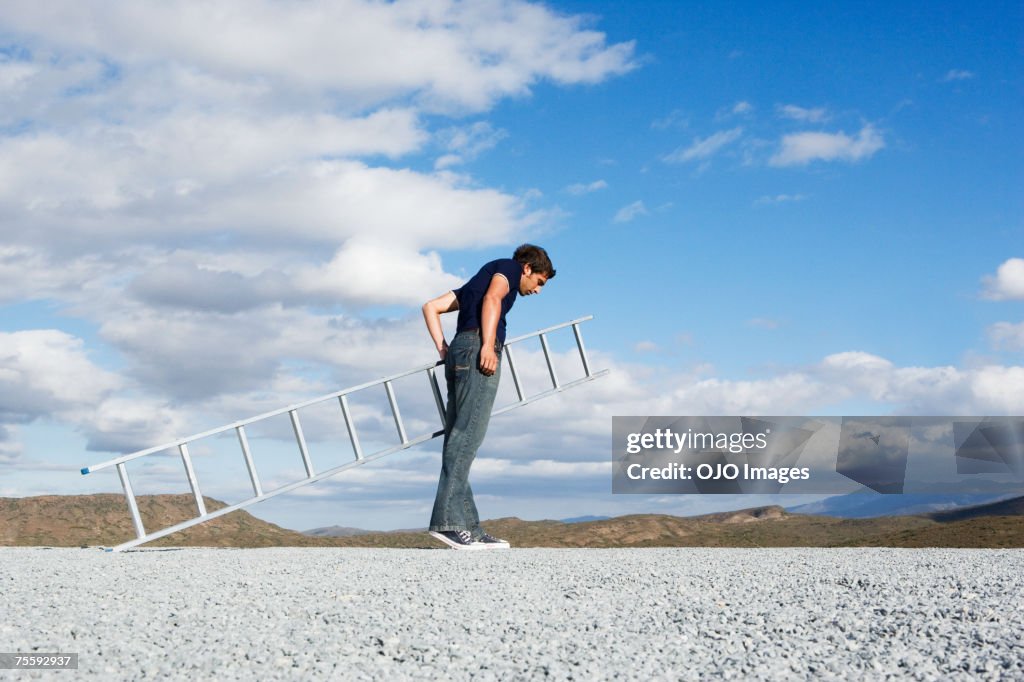 Man looking down with ladder