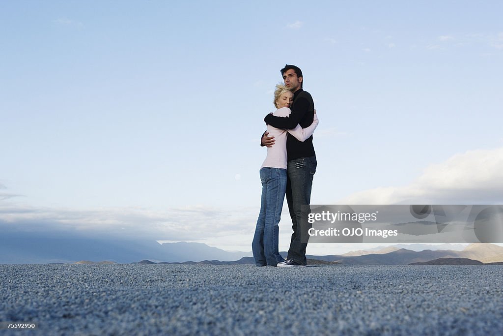 Man and woman embracing outdoors