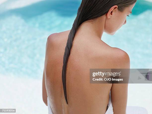 woman sitting outdoors by a swimming pool - bar överkropp bildbanksfoton och bilder