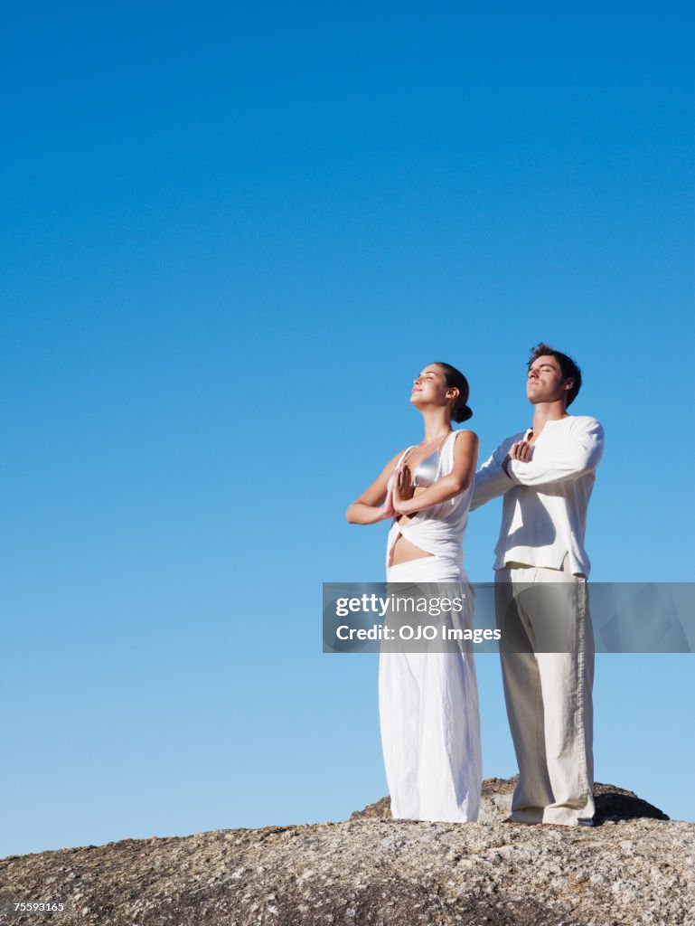 A man and a woman doing yoga