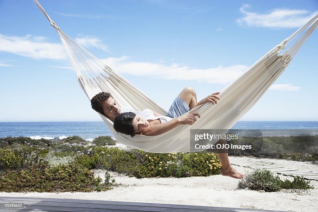 A couple sleeping in a hammock