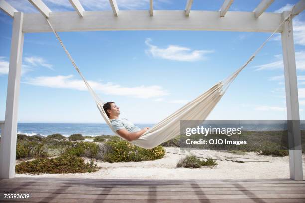 man sleeping in a hammock - hammock stock pictures, royalty-free photos & images