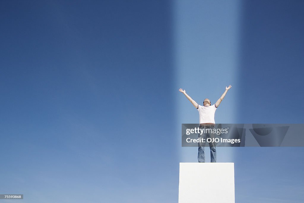 Man with a beam of light shining straight onto him