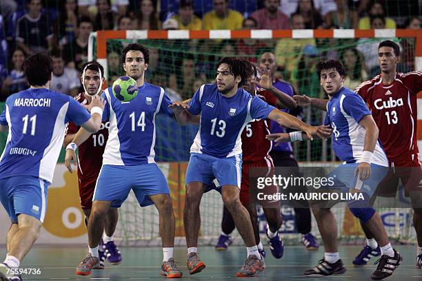 Rio de Janeiro, BRAZIL: Uruguay's Pablo Marrochi receives the ball to lose the last throw of the team against Cuba in the final seconds of their Rio...