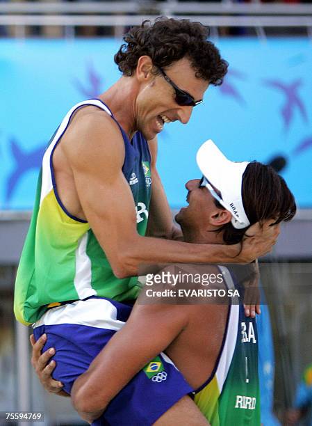 Rio de Janeiro, BRAZIL: Brazilian player Emanuel Rego and Ricardo Santos celebrate after defeating US players Hans Stolfus and Ty Loomis in the Beach...