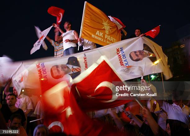 Supporters of Turkey's Prime Minister Recep Tayyip Erdogan's party Justice and Development Party celebrate the victory for the general election at...