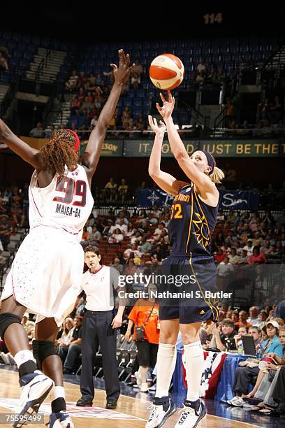 Katie Douglas of the Connecticut Sun shoots against Hamchetou Maiga-Ba of the Houston Comets at Mohegan Sun July 22, 2007 in Uncasville, Connecticut....