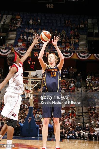 Margo Dydek of the Connecticut Sun shoots against Michelle Snow of the Houston Comets at Mohegan Sun July 22, 2007 in Uncasville, Connecticut. NOTE...