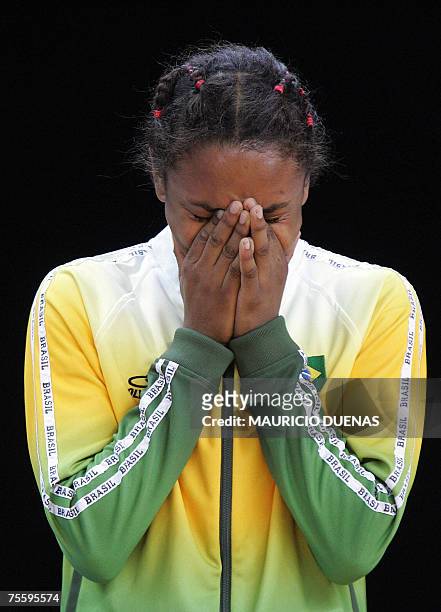 Rio de Janeiro, BRAZIL: Brazil's Erika Miranda cries during the award ceremony after losing against Cuba's Sheila Espinosa in the women Judo 52kg...