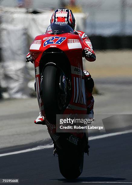 Casey Stoner of Australia rider of the Ducati makes a wheelie after winning the 2007 Red Bull U.S. Grand Prix, part of the MotoGP World...