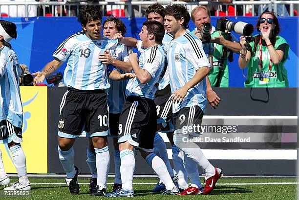 Matias Sanchez of Argentina and Mauro Zarate of Argentina celebrate with teammate Sergio Aguero who scored to tie the game against the Czech Republic...