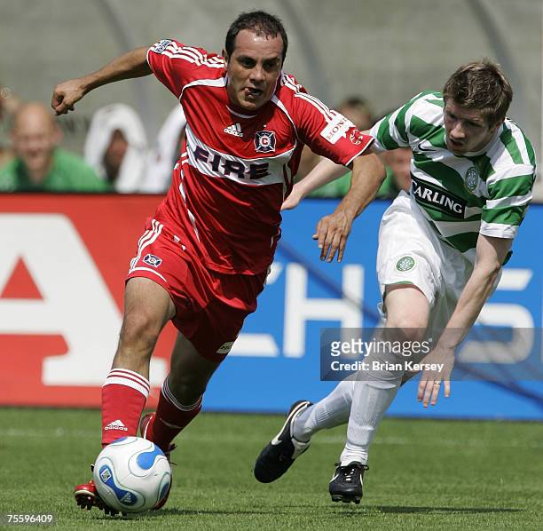 Chicago Fire's Cuauhtemoc Blanco, left, forces his way past Celtic FC's Mark Wilson during the first half of a soccer game at Toyota Park in...