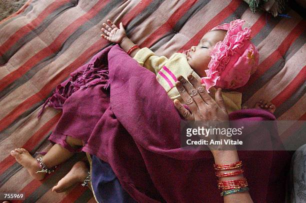 Abdin Banu sleeps inside a mosque March 5, 2002 in central Ahmadabad, India. Over 5000 Muslims have taken refuge inside the mosque and an estimated...