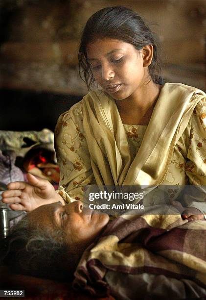 Reshna Bibi, seated, looks after relative Nafisa Bibi inside a mosque March 5, 2002 in central Ahmadabad, India. Over 5000 Muslims have taken refuge...