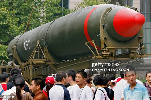 Visitors walk past China's second nuclear missile on display as they visit the Military Museum in Beijing, 23 July 2007. The US military 22 July said...