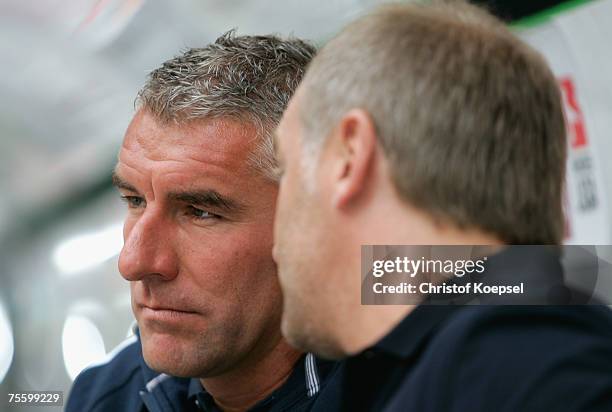 Head coach Mieko Slomka of Schalke and manager Andreas Mueller talk before the Premiere Liga Cup match between FC Schalke 04 and Karlsruher SC at the...