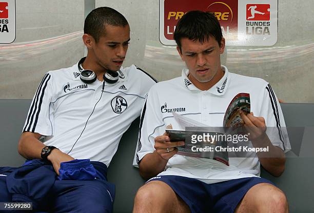 Mimoun Azaouagh and Zlatan Bajramovic of Schalke read a matchday magazine before the Premiere Liga Cup match between FC Schalke 04 and Karlsruher SC...