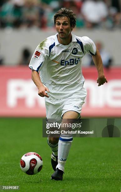 Christian Eichner of Karlsruhe runs with the ball during the Premiere Liga Cup match between FC Schalke 04 and Karlsruher SC at the LTU Arena on July...