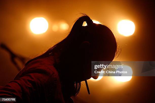 Liu Yijun of the "Tang Dynasty" band performs at the first "Green Flag - Erdos Grassland Rock Music Festival" near the Mausoleum of Genghis Khan on...